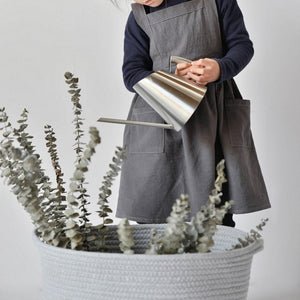 Kids pinafore apron in charcoal, linen and cotton fabric, tie back and roomy pockets in front